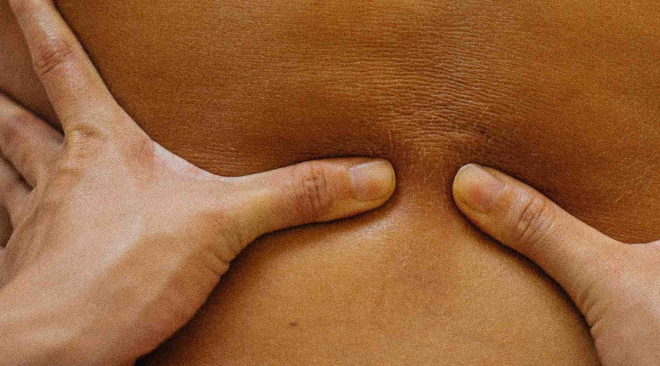 hands pressing on skin for a blog about body massage oil